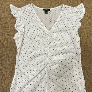 Sheer sleeveless white shell with black polka dots